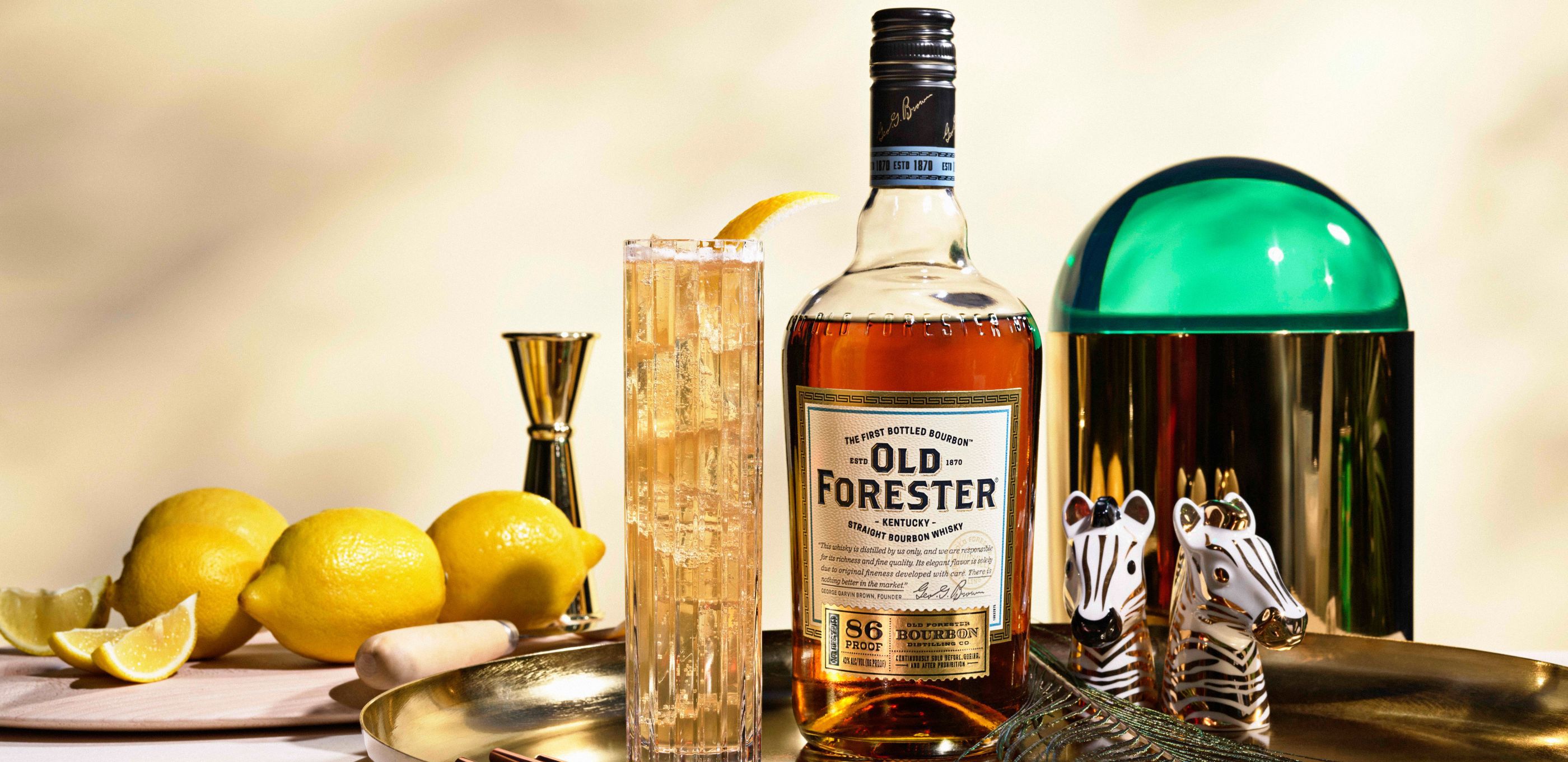 A bottle of Old Forester with a cocktail